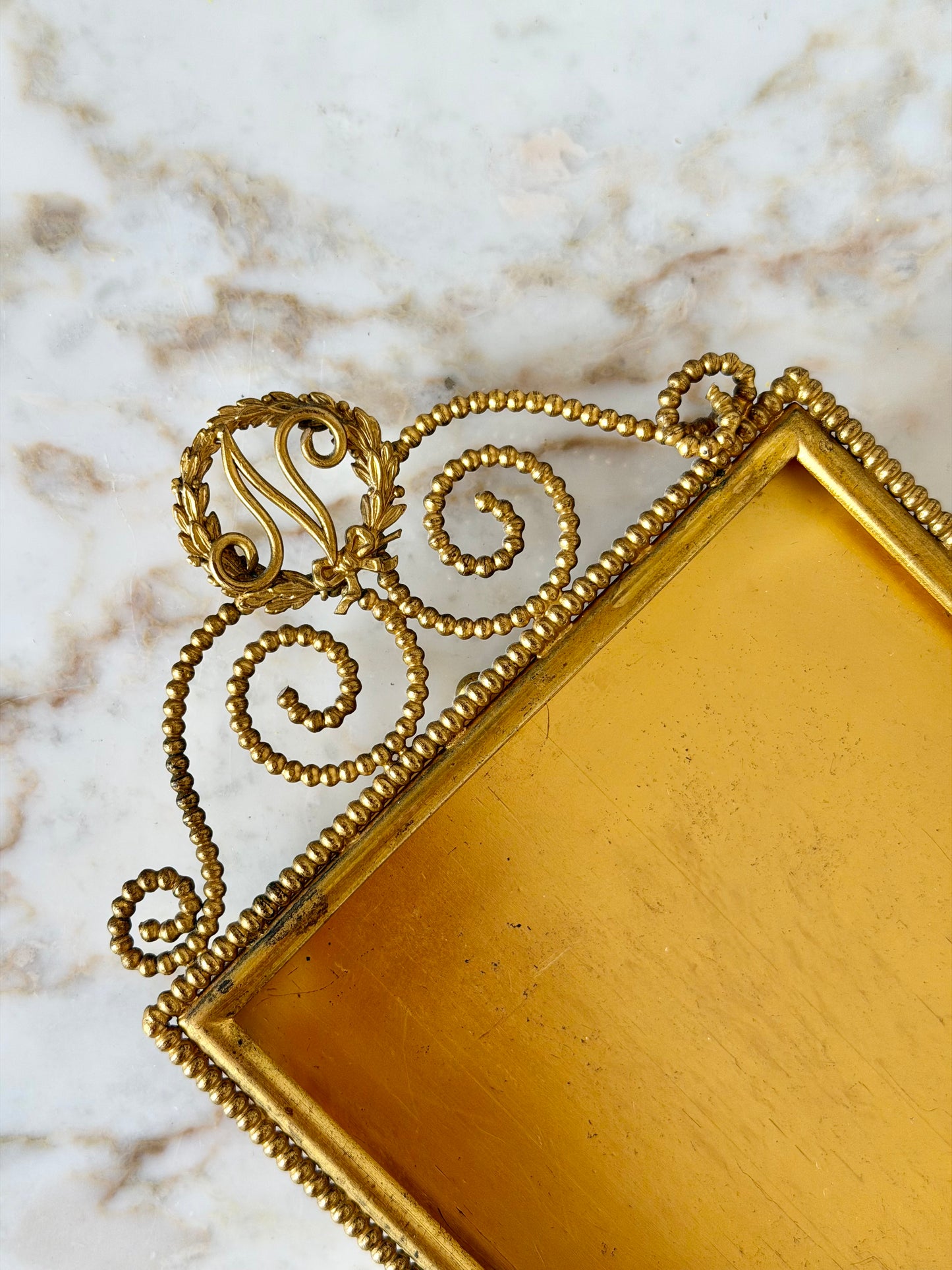 Gilt initial “N” frame