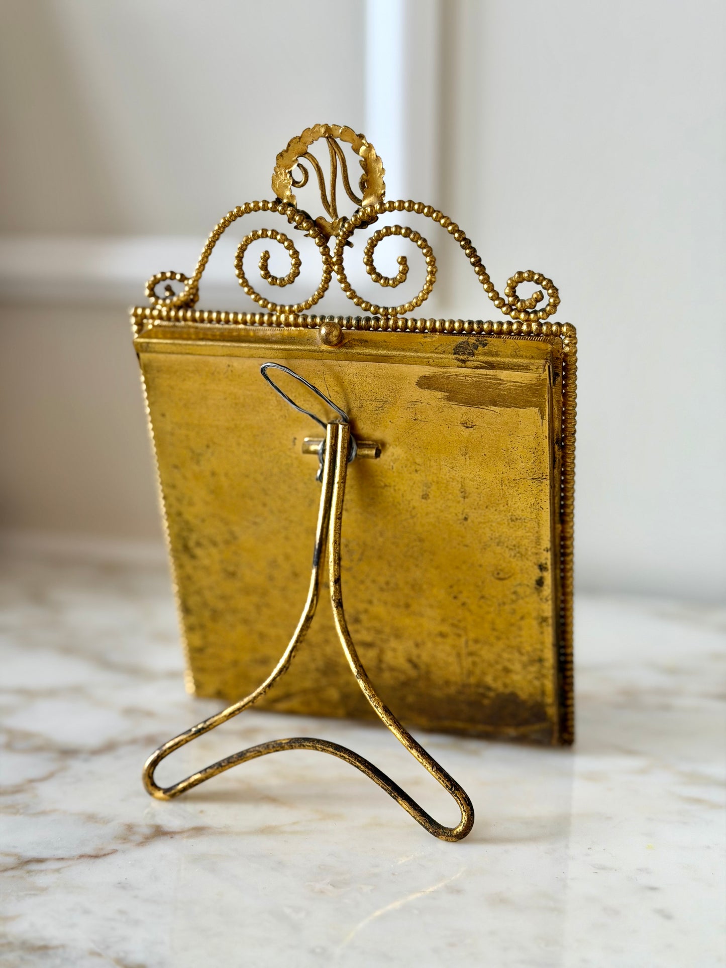 Gilt initial “N” frame