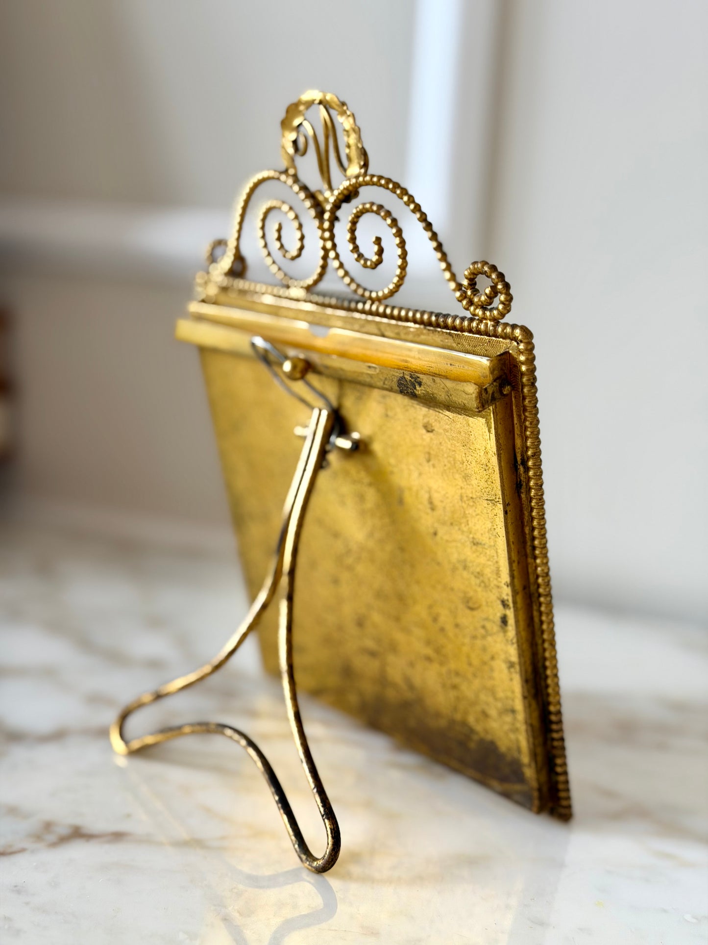 Gilt initial “N” frame